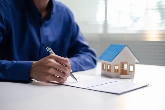 insurance agent sitting with homeowners reviewing their policy